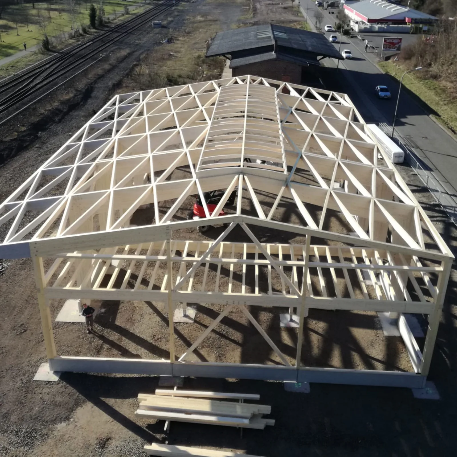 Aerial view of a hall roof with timber purlins arranged in an X pattern